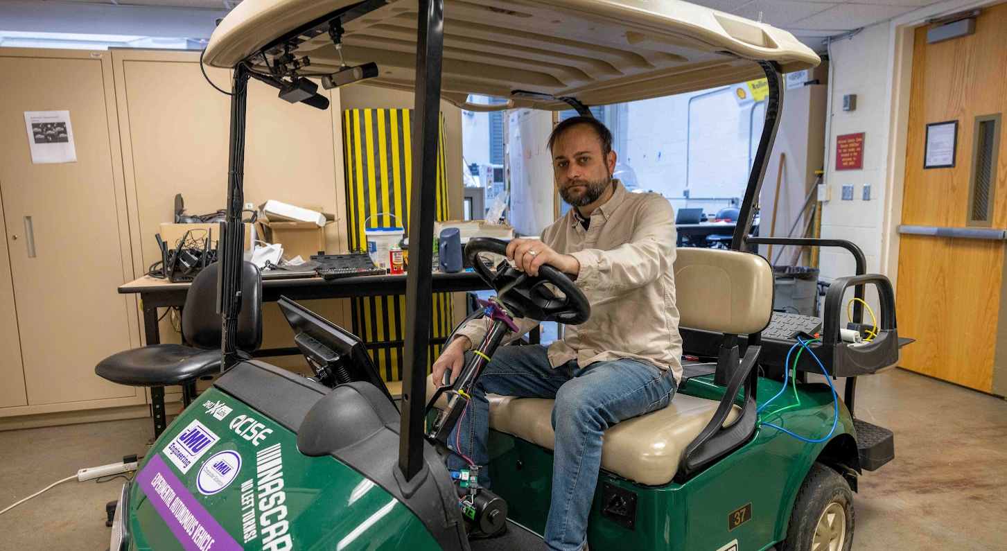 Bobby sitting on golf cart in lab