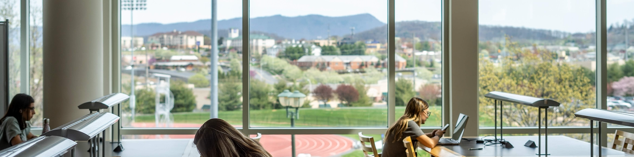 Photo of students studying in Rose Library overlooking the mountains